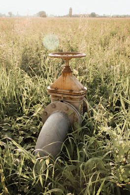 Automated valve system installed on a remote pipeline surrounded by desert landscape.