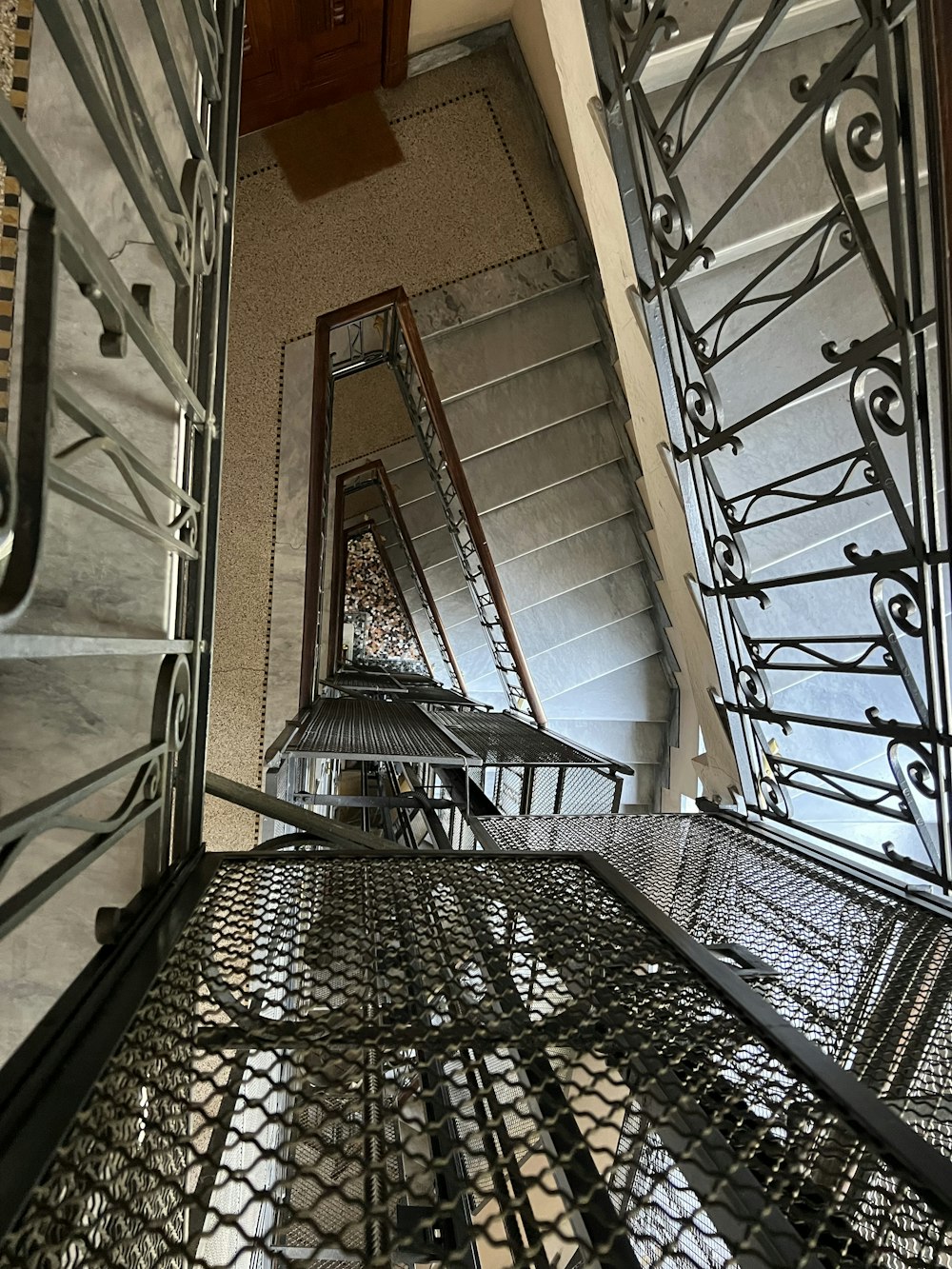 a set of stairs with metal railings in a building