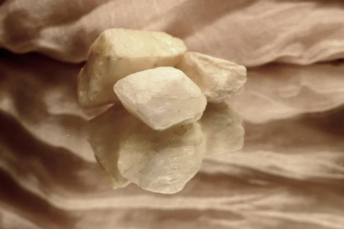 A collection of various flint stones displayed with soft natural lighting emphasizing their unique shapes.
