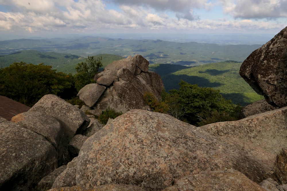 a view of a mountain range from a rocky outcrop