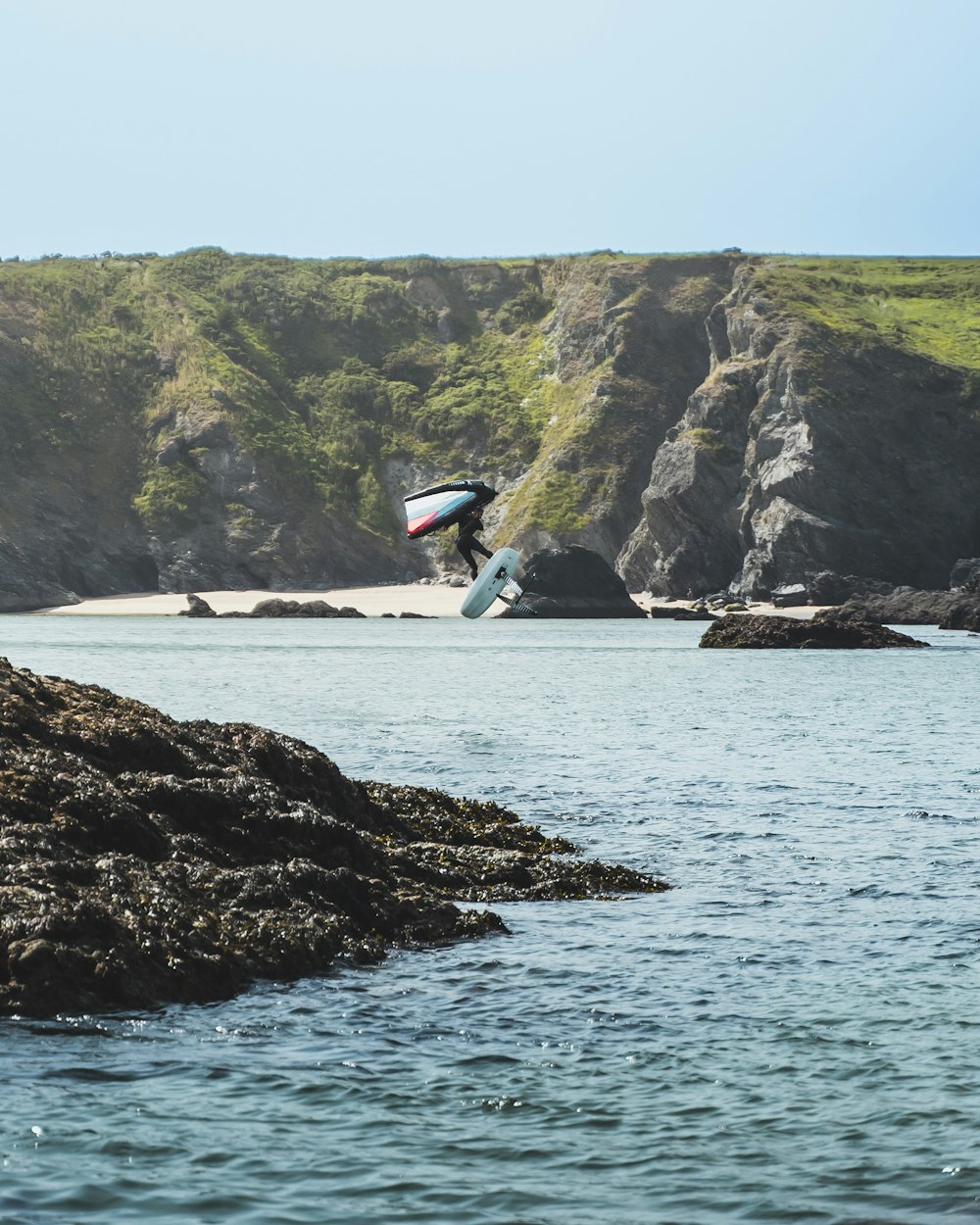 a person jumping in the air with a surfboard