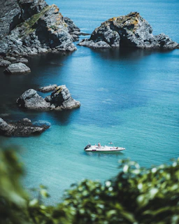 a small boat in the middle of a body of water