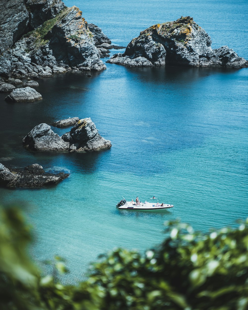 a small boat in the middle of a body of water