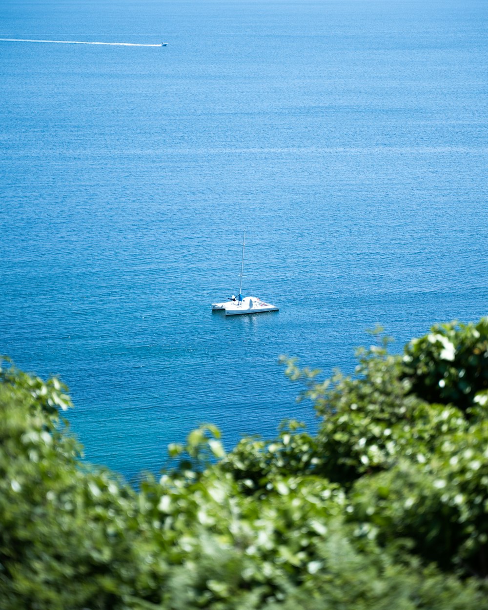 a small boat floating on top of a large body of water