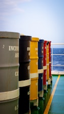 a row of buckets sitting on the side of a boat