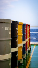a row of buckets sitting on the side of a boat
