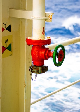 a red fire hydrant on the side of a boat