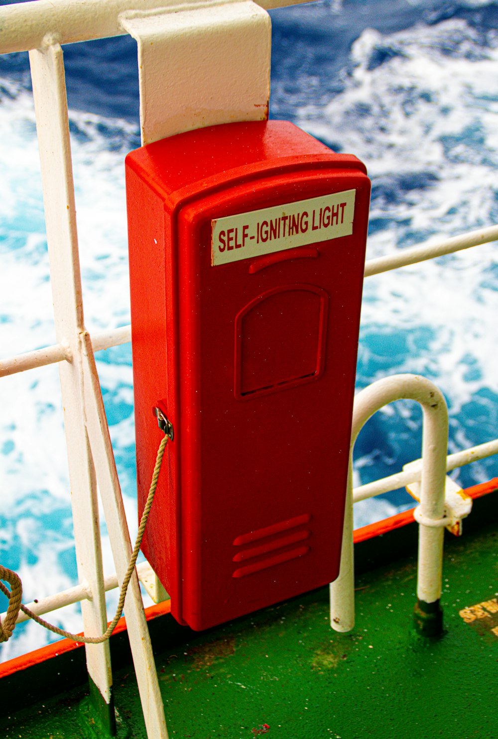 a red box sitting on the side of a boat