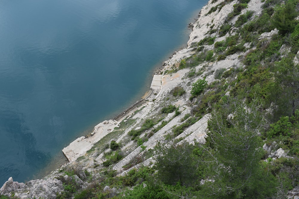 a large body of water next to a rocky cliff