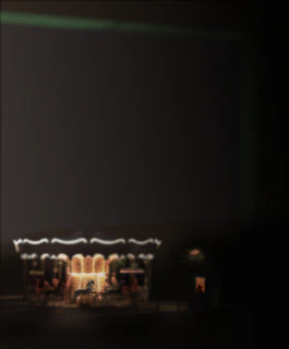A creepy carousel with distorted clown faces spinning under a blood-red moon.