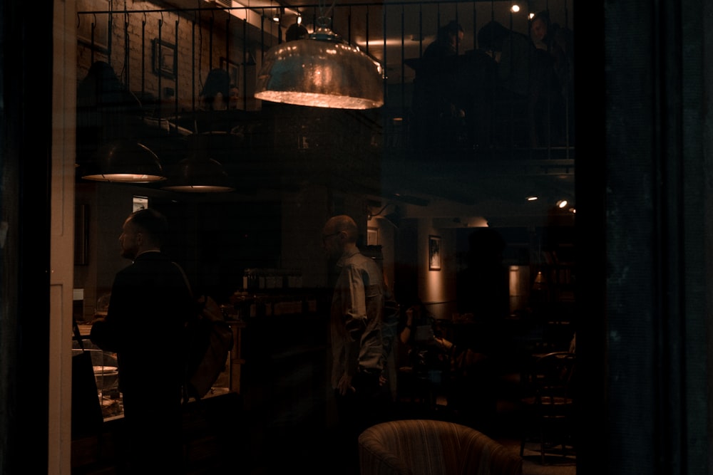 a group of people standing around a kitchen