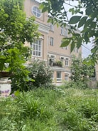 A cozy residential building with green surroundings.