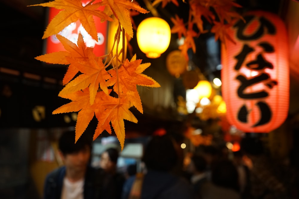 a group of people walking down a street next to a tree