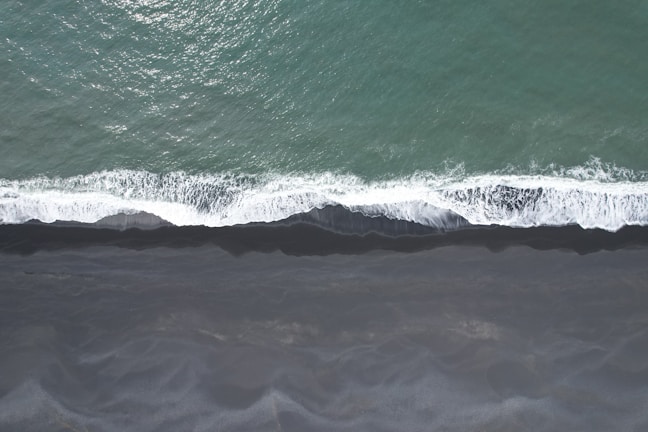 an aerial view of the ocean with waves