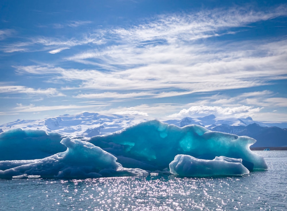 a large iceberg floating on top of a body of water