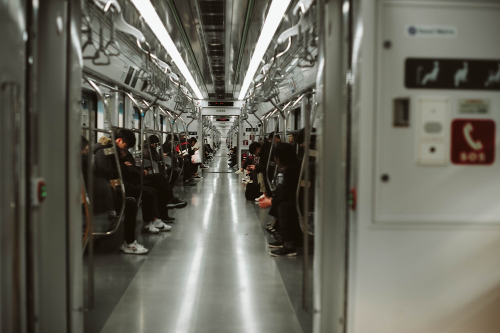 a subway car with people sitting in it