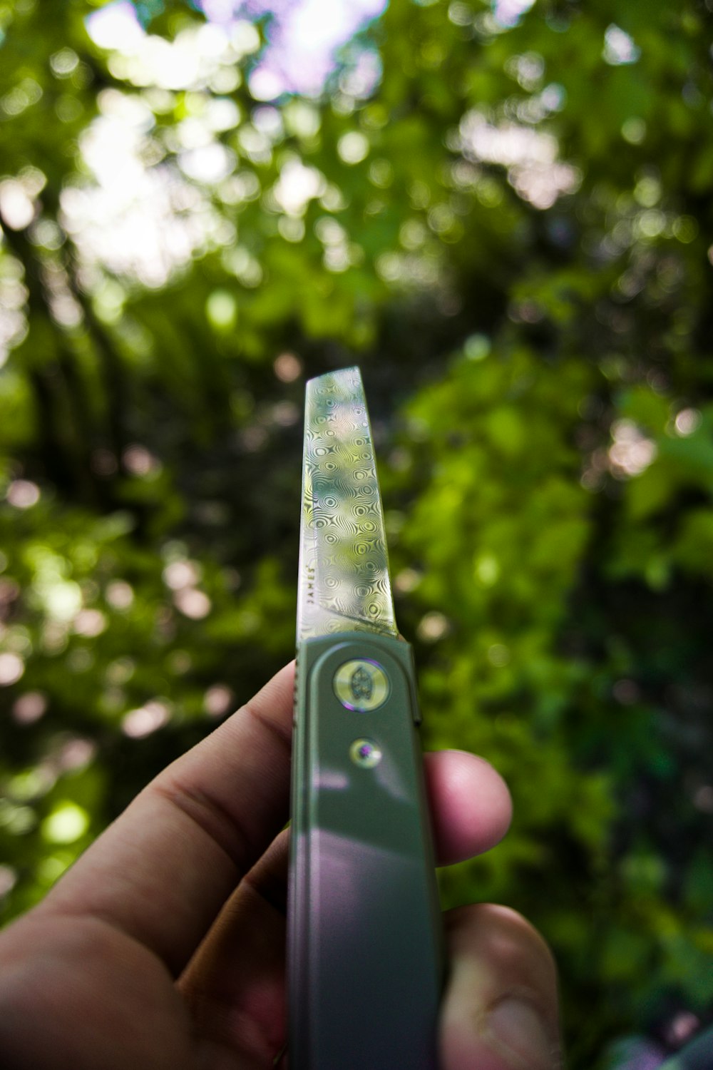 a person holding a green electronic device in their hand