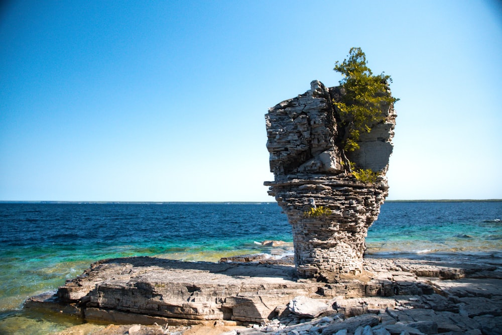 a rock outcropping in the middle of the ocean