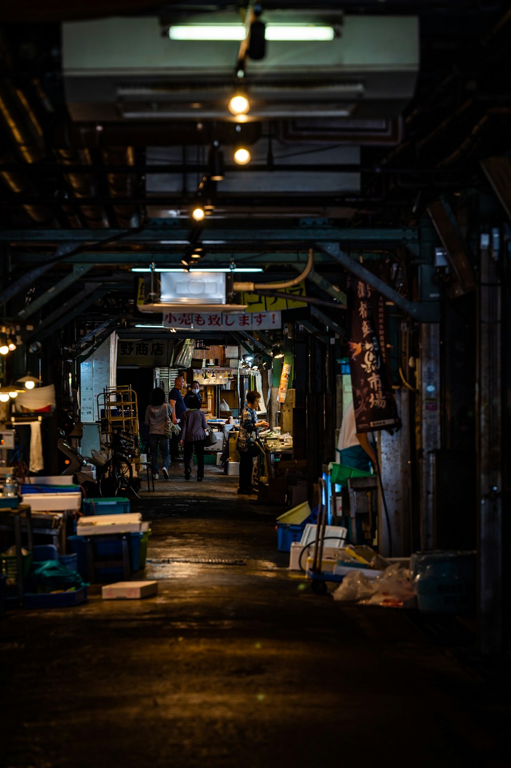 a dark alley way with lots of items on display