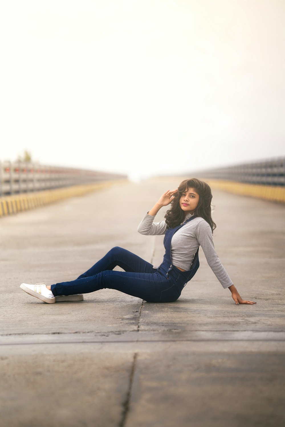 a woman sitting on the ground with her legs crossed