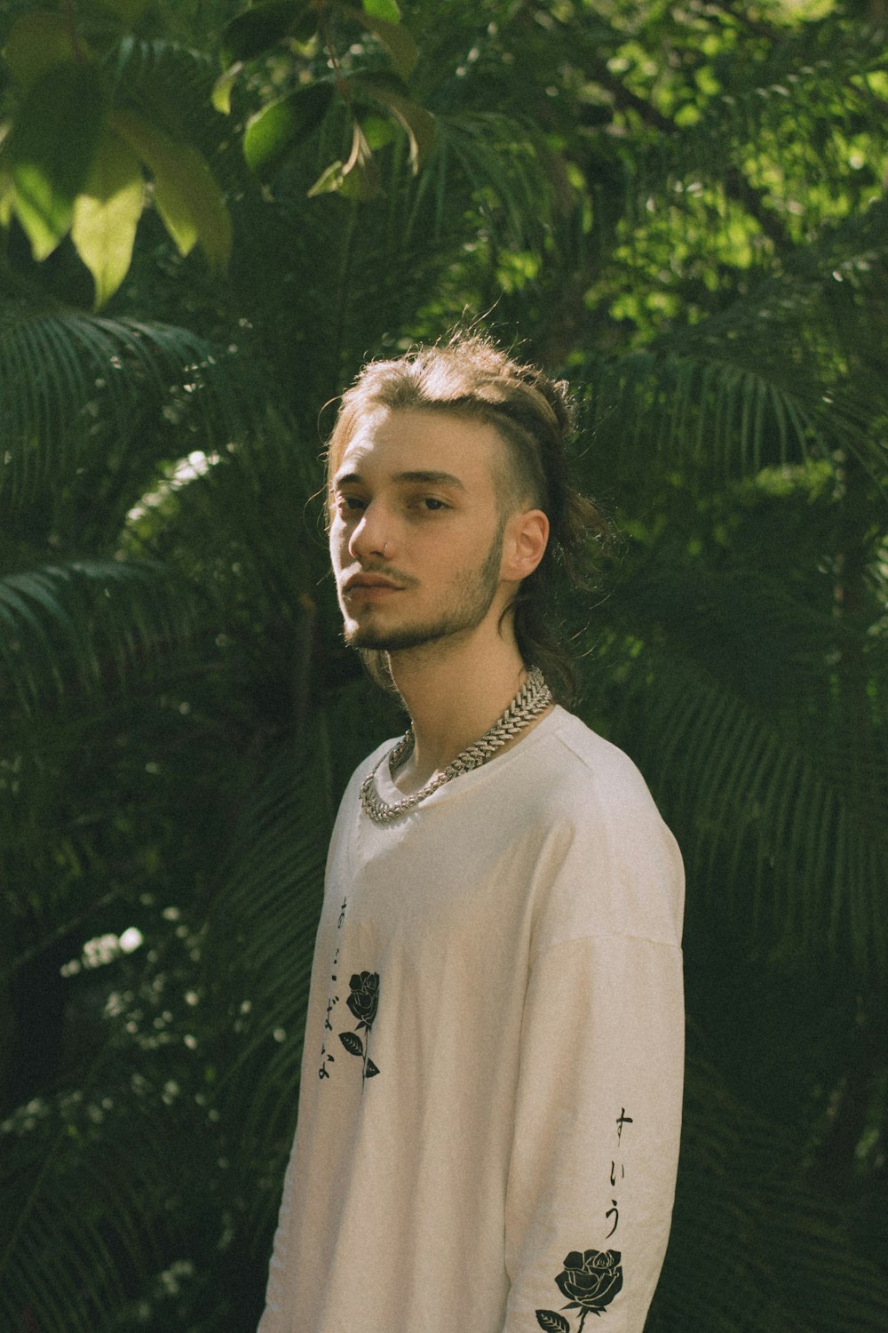 a man standing in front of some trees