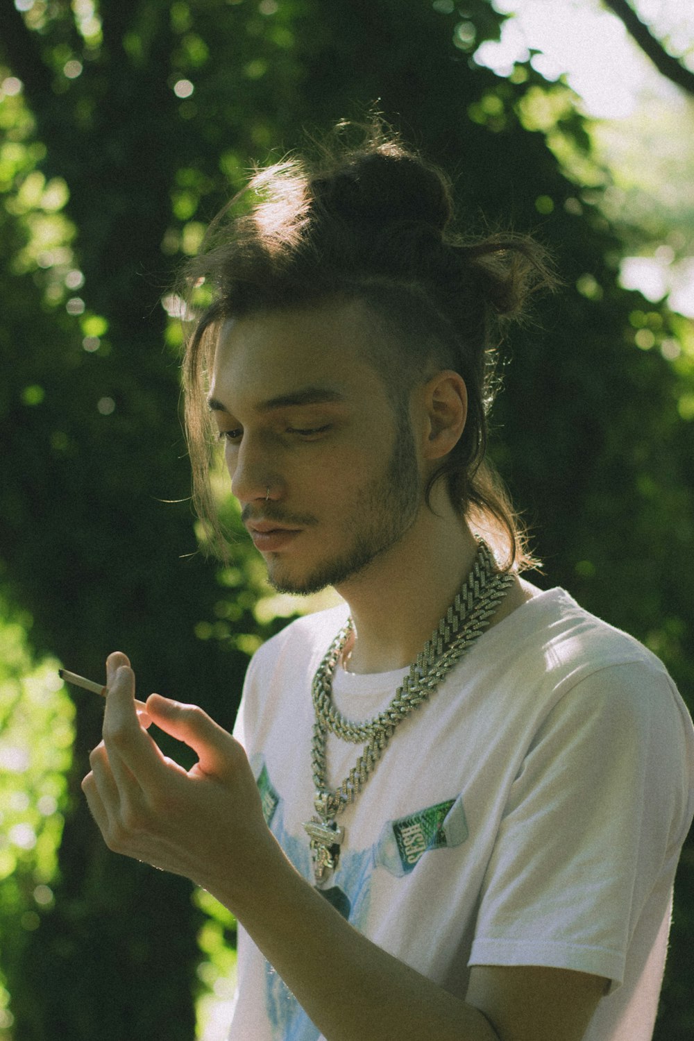 a man smoking a cigarette in a park