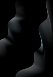 Abstract floating device with subtle gradient lighting, tilted diagonally in deep charcoal tones.