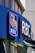 A modern building facade features a prominent logo that includes a blue background with a golden lion and globe. The letters 'RBC' are boldly displayed next to the logo, indicating a business establishment. The structure is made of glass and metal, with reflections visible on the windows.