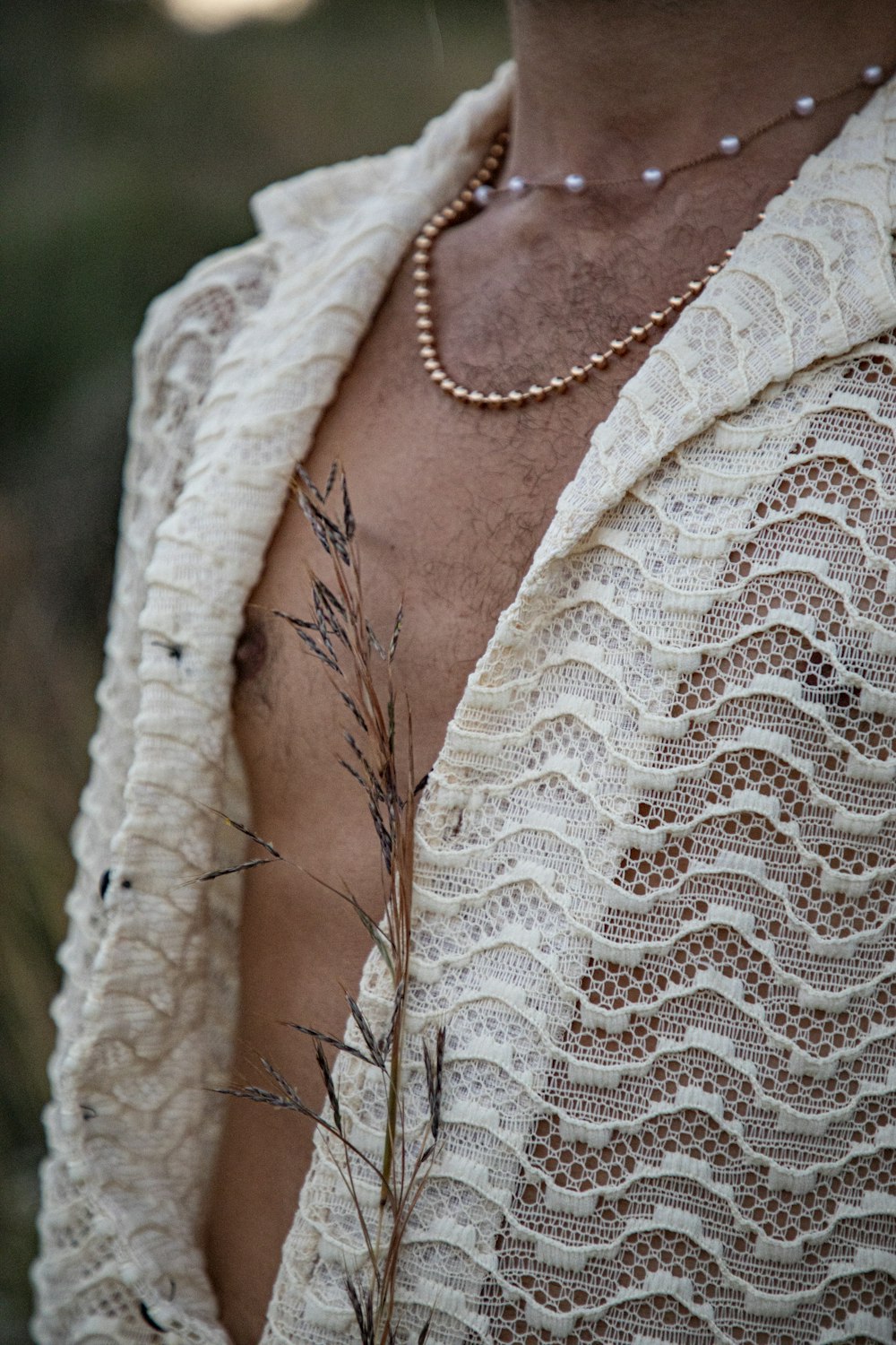 a close up of a person wearing a shirt and a necklace