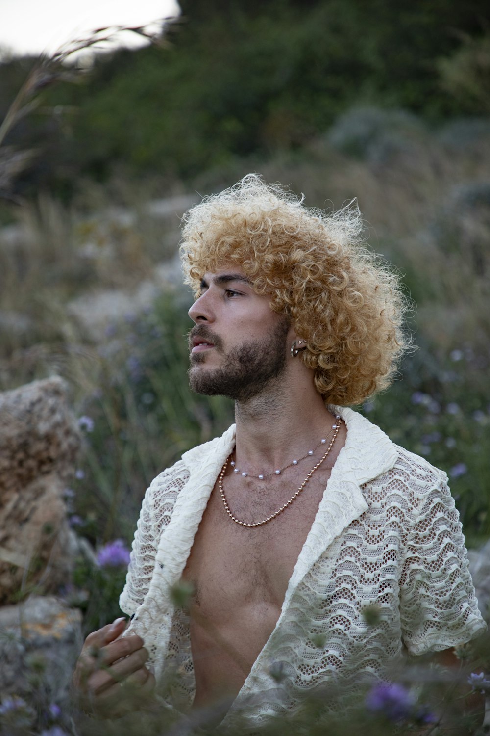 a man with blonde hair wearing a white shirt