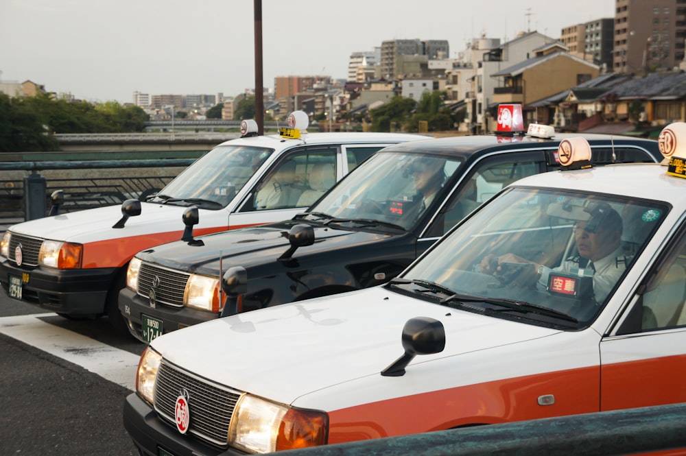 a row of taxi cabs parked next to each other