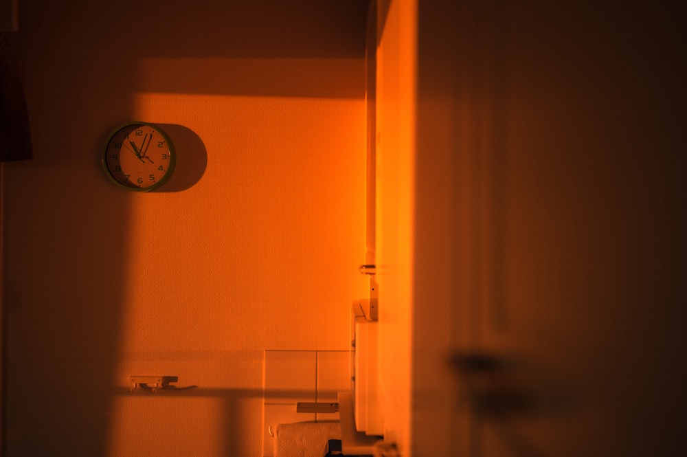 a clock on the wall of a bathroom