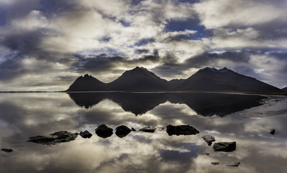 a large body of water with mountains in the background