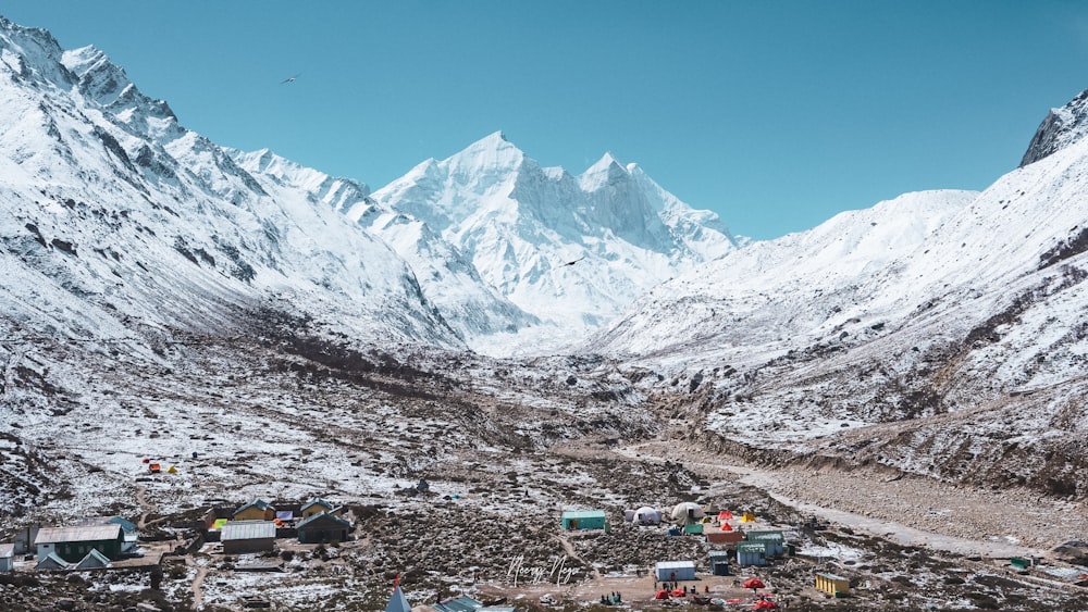 a group of tents in the middle of a mountain range