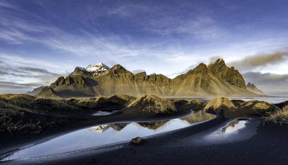 a mountain range with a body of water in the foreground