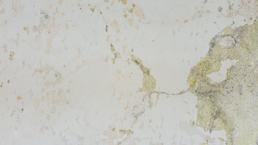 Close-up of drywall being patched on an aged wall.