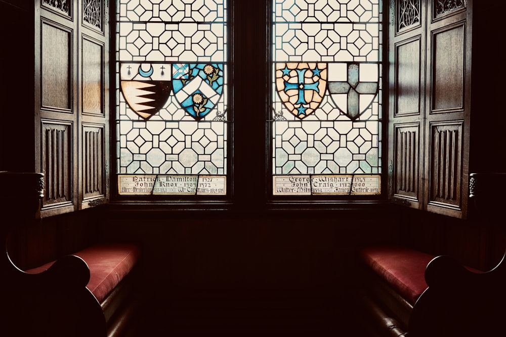 two stained glass windows in a dark room