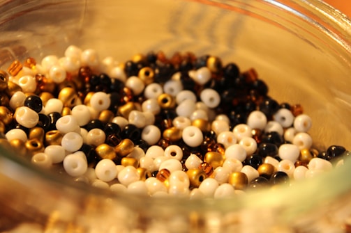a glass bowl filled with black and white beads