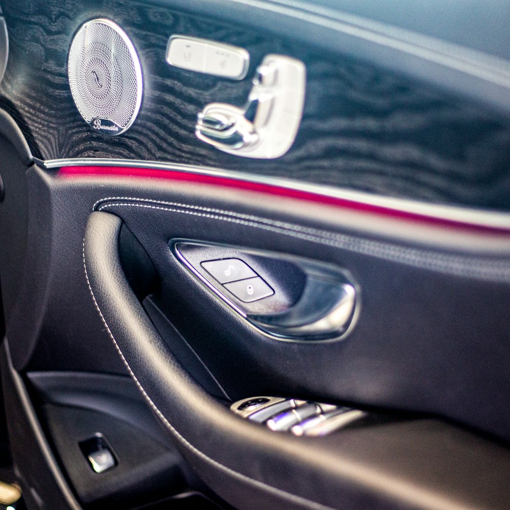 a close up of a car door handle and a steering wheel