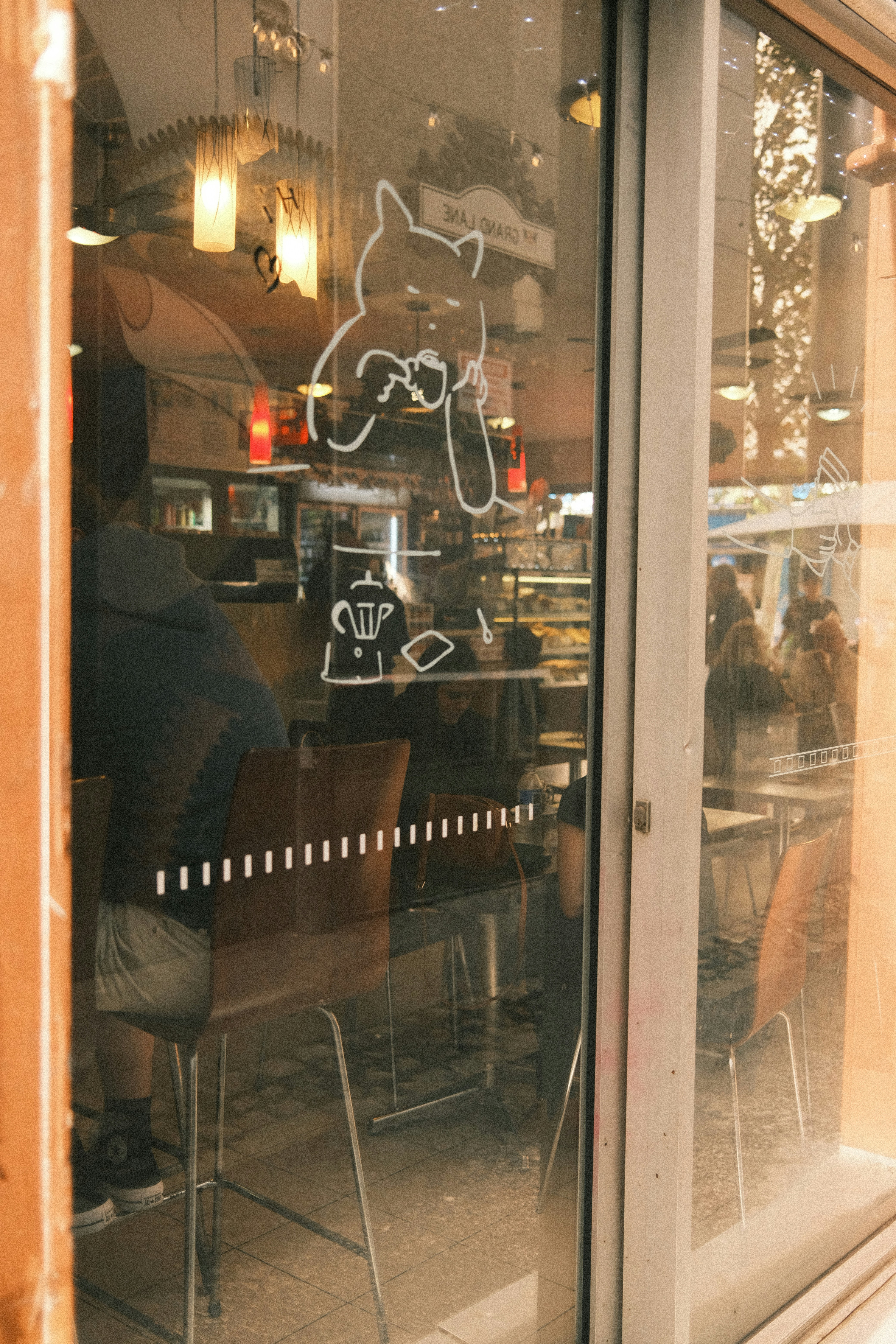 a man sitting at a table in front of a window