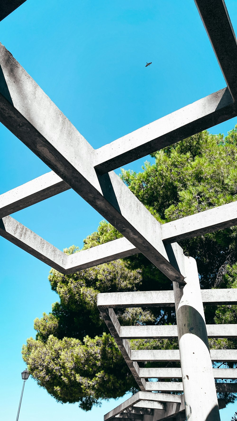 a metal structure with trees in the background