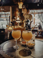 A lively evening scene with guests enjoying flavorful dishes and handcrafted cocktails at Sahara Sips.