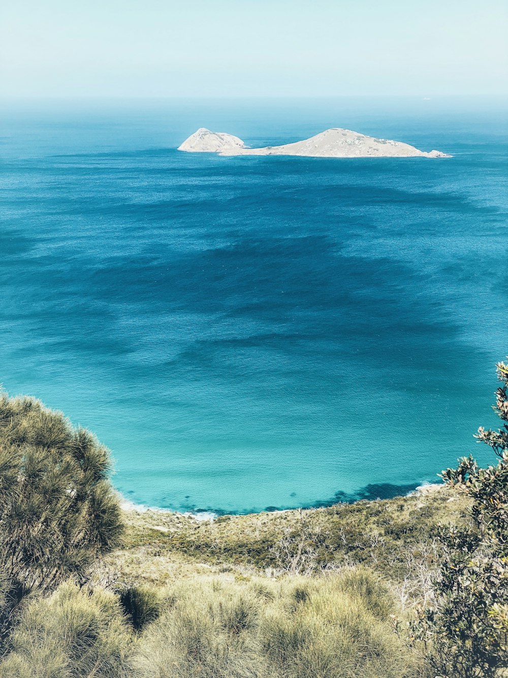 a view of a body of water with a small island in the distance