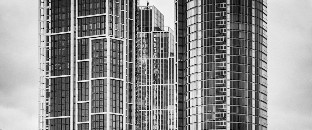 a black and white photo of two tall buildings