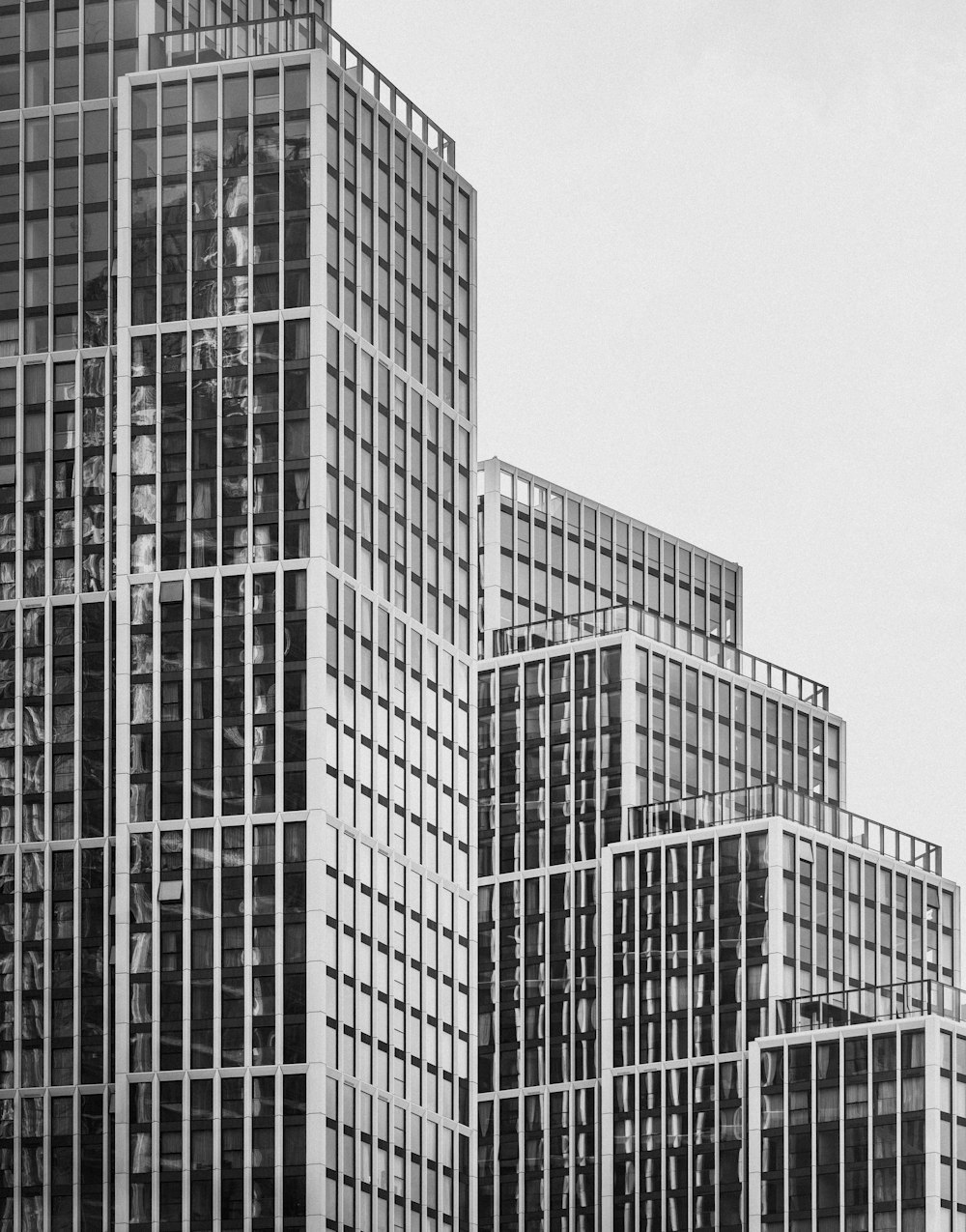 a black and white photo of some very tall buildings