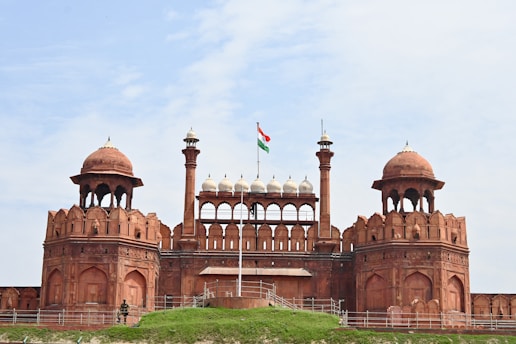 a large building with two towers and a flag on top