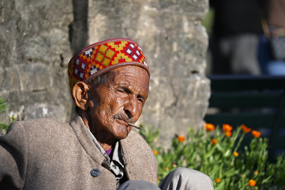 an old man with a pipe in his mouth