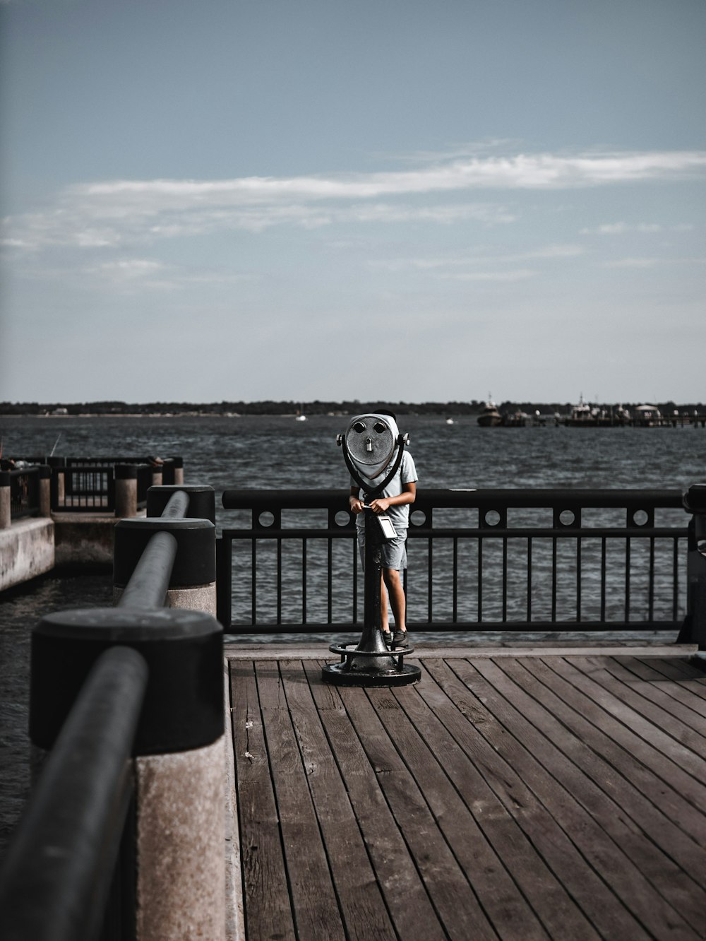 a person standing on a skateboard on a pier