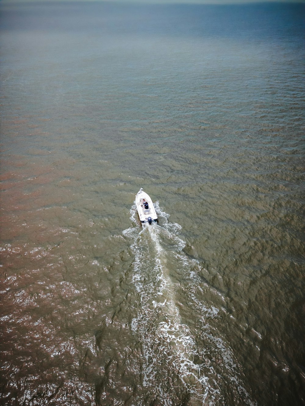 a small boat in the middle of a body of water