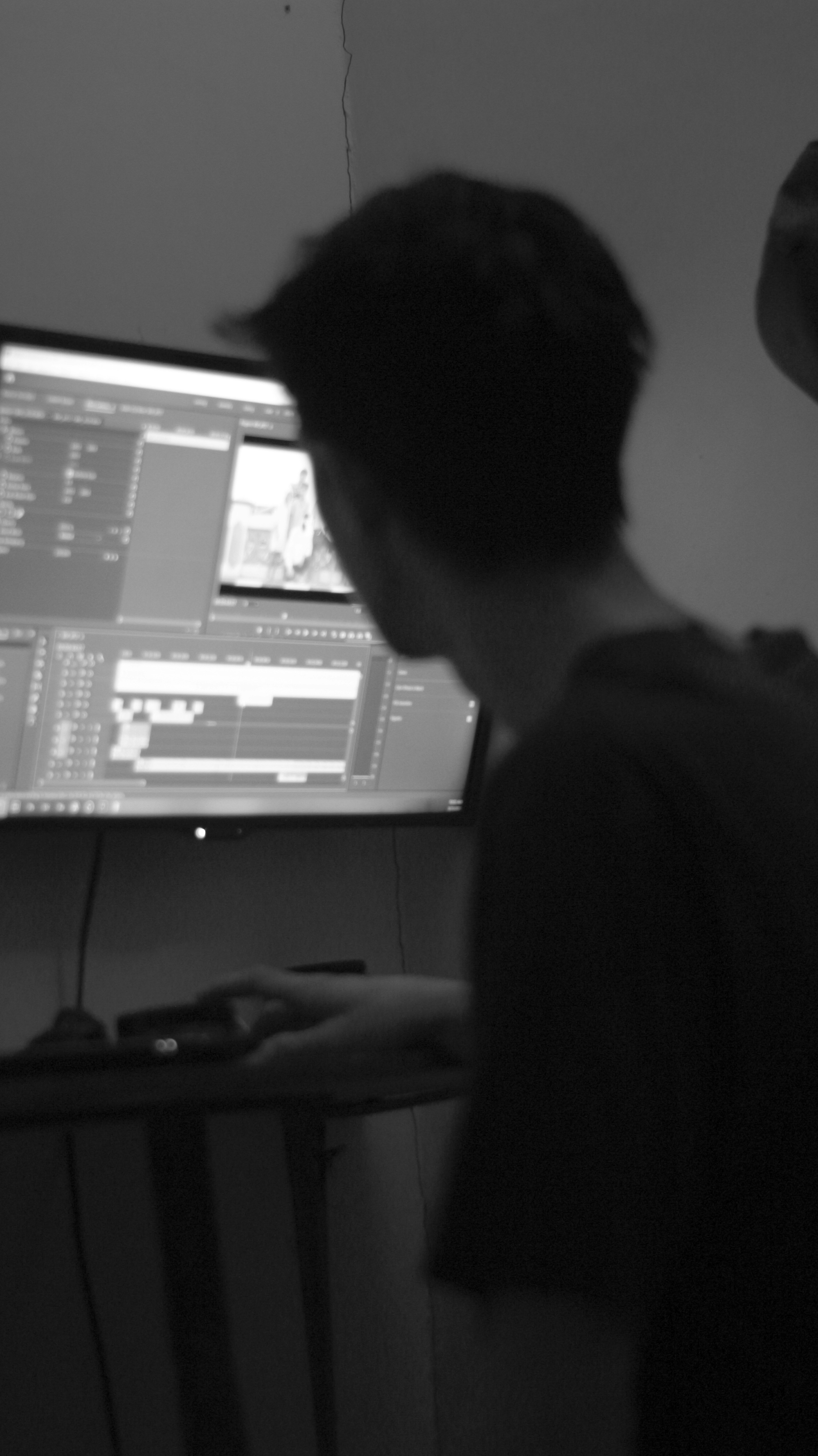 a man standing in front of a computer monitor